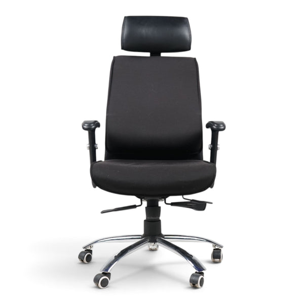 Refurnish by Loopr black ergonomic office chair with headrest, adjustable armrests, and chrome base on wheels.