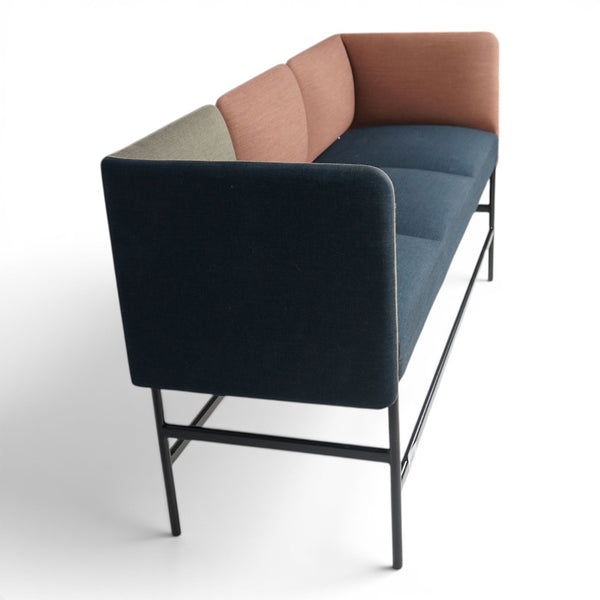 Refurnish by Loopr Foraform Barsofa with multi-colored fabric upholstery in blue, peach, and sage on a black frame.