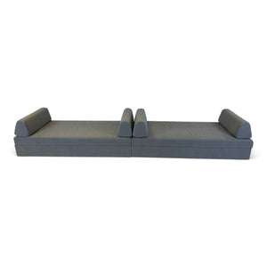 Refurnish by Loopr grey fabric sofa bed in flat sleeping position, featuring a minimalist design for guest rooms.