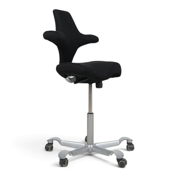 Refurnish by Loopr HÅG Capisco 8106 ergonomic office chair with a black saddle seat and silver grey base