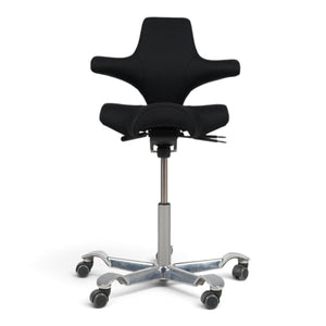 Refurnish by Loopr HÅG Capisco 8106 ergonomic office chair with black saddle seat and silver base on white background