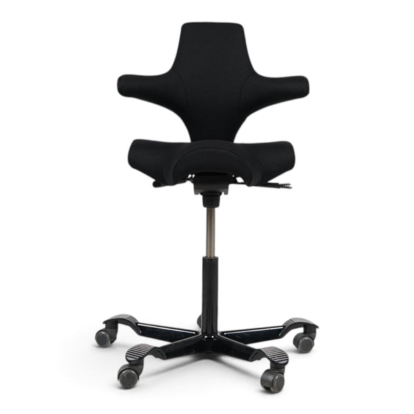Refurnish by Loopr HÅG Capisco 8106 ergonomic office chair with a black saddle seat and black five-star base.