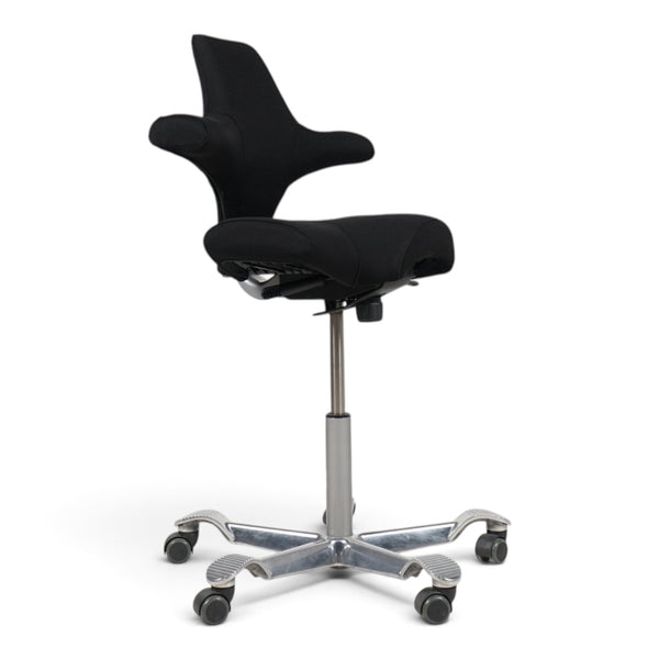 Refurnish by Loopr HÅG Capisco 8106 ergonomic office chair with a black saddle seat and silver base on wheels.