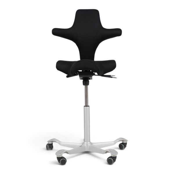 Refurnish by Loopr HÅG Capisco 8106 ergonomic office chair with black saddle seat and grey base on a white background