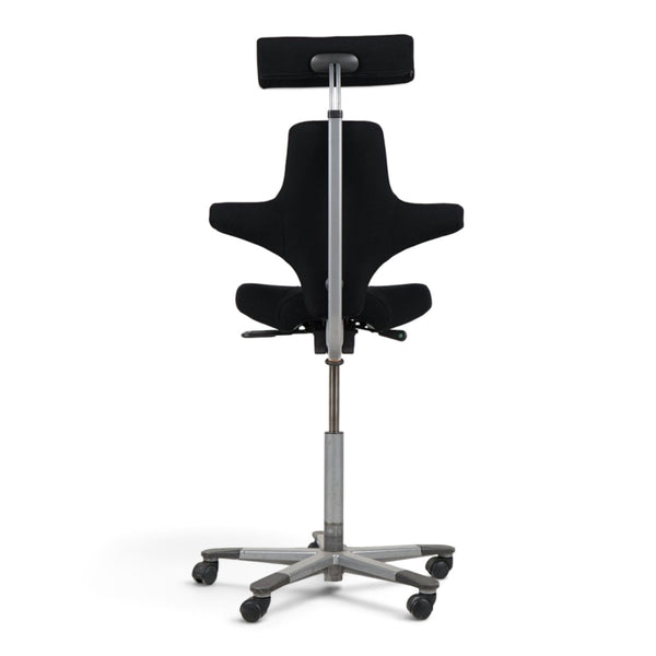 Refurnish by Loopr HÅG Capisco office chair with black upholstery, grey base, and adjustable headrest, rear view