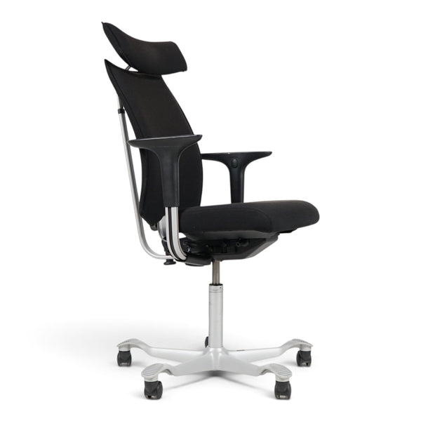 Refurnish by Loopr HÅG H05 5600 ergonomic office chair in black fabric with headrest, armrests, and grey base.
