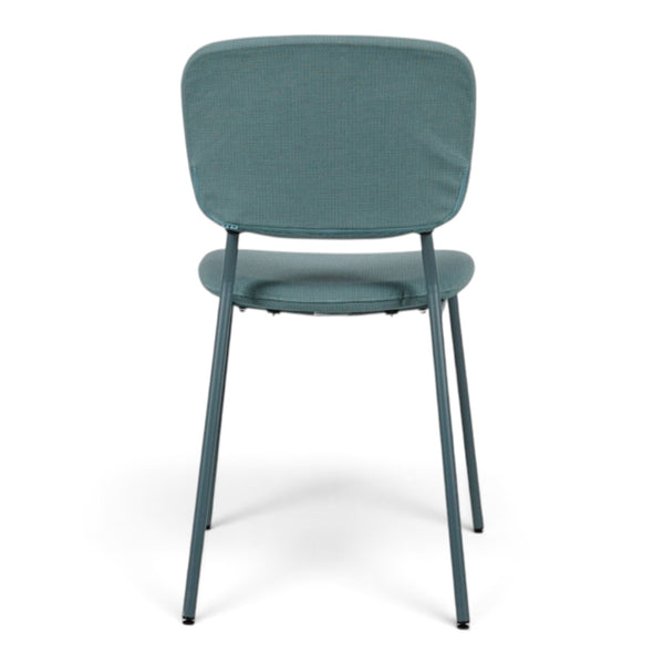 Refurnish by Loopr light green stackable chair with fabric seat and backrest on a metal frame, back view.