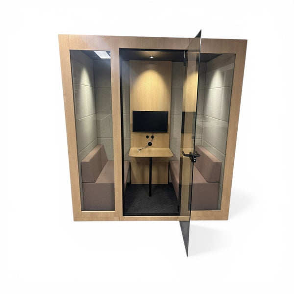 Refurnish by Loopr Silent Room M acoustic pod with light wood frame, glass door, two benches, and a desk with monitor.