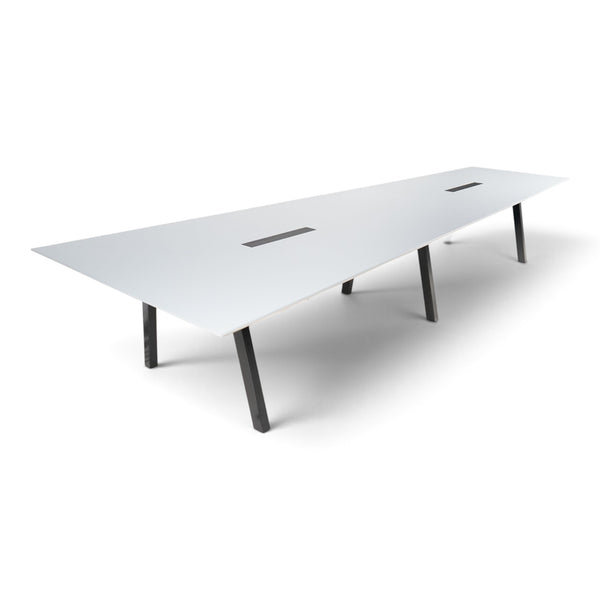 Refurnish by Loopr trapezoid meeting table with a white top and black legs, designed for large office conferences.